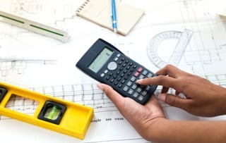Avoid Costly Surprises: Mastering Construction Estimations 2 woman using calculator near plan equipments